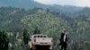 FILE - A Taliban militant is seen walking in Pakistan's tribal region of North Waziristan. Aug. 12, 2013. American author Paul Overby was hoping to reach to the region when he went missing in May of 2014.